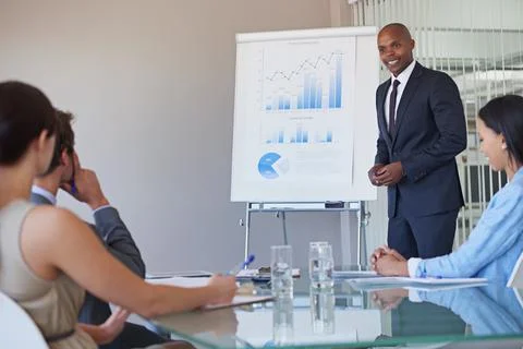 All our hard work has paid off. a business manager presenting financial data to Stock Photos