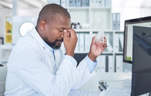All problem solving and no play...a scientist looking stressed while conducting Foto stock