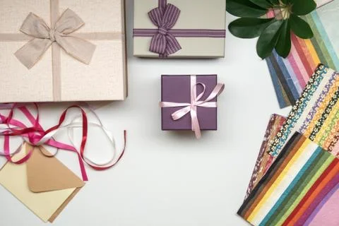 All things for gift wrapping. Present box with bow. Ribbon and color paper. Stock Photos