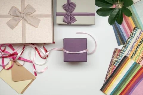 All things for gift wrapping. Present box with bow. Ribbon and color paper. Stock Photos