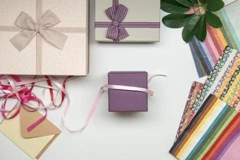 All things for gift wrapping. Present box with bow. Ribbon and color paper. Stock Photos