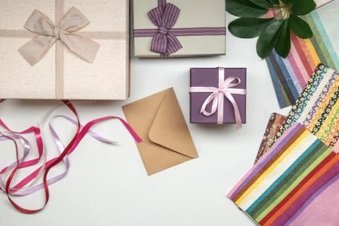 All things for gift wrapping. Present box with bow. Ribbon and color paper. Stock Photos