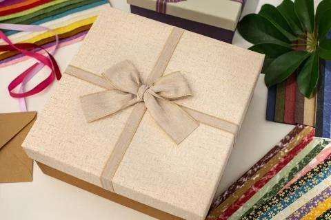All things for gift wrapping. Present box with bow. Ribbon and color paper. Stock Photos