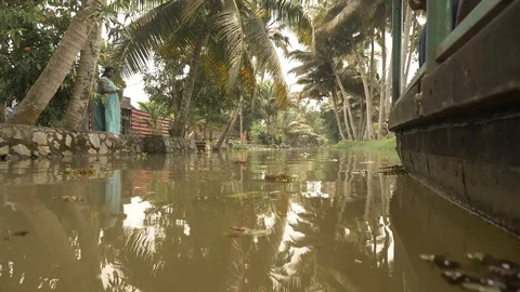 ALLEPPEY, India - a canoe moves down a canal on the Alleppey backwaters Stock Footage 85702000