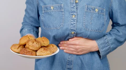 Allergy to wheat. Avoiding flour cookies. Gluten intolerance. Abdominal pain Stock Footage 255651725