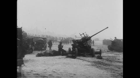 Allied soldier operating howitzer on beach at Normandy Stock Footage 44574761