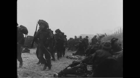 Allied soldiers taking position on beach at Normandy Stock Footage