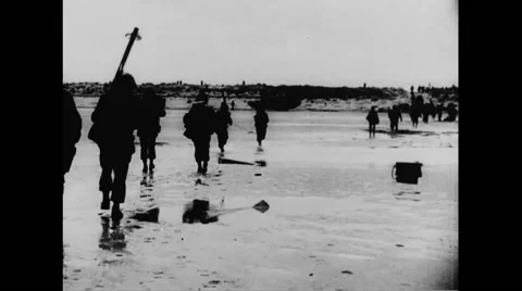 Allied soldiers walking on beach Stock Footage 44575281