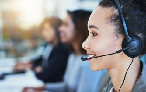 Allow me to direct your call. Shot of a young woman working in a call centre. Stock Photos