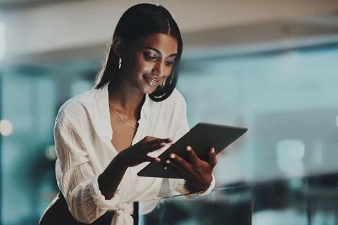 Allow technology to help evolve your business. a young businesswoman using a Stock Photos