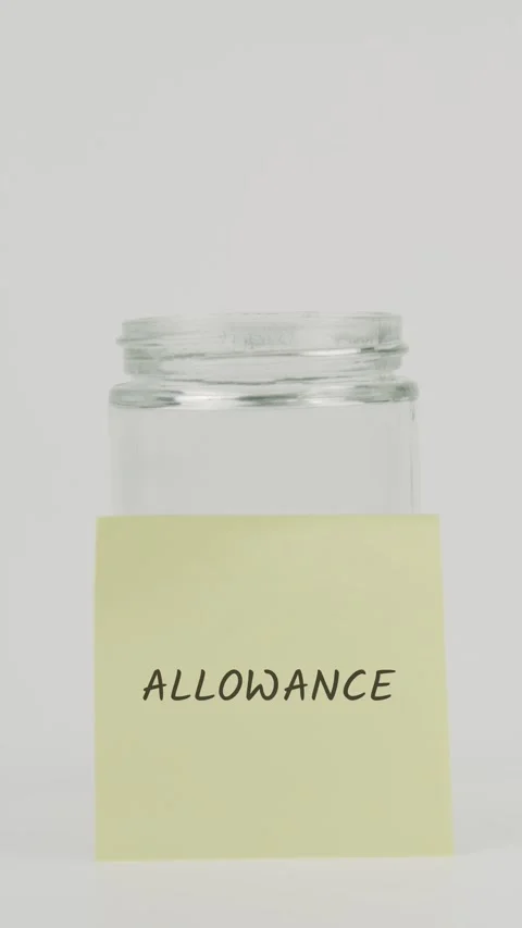 Allowance text or word on yellow sticky note attached to glass jar with hand Stock Footage 311677100