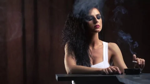 Alluring model posing with a cigarette. 動画素材 79435389