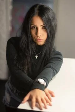 Alluring young brunette posing in a studio. Stock Photos