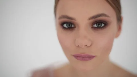 Alluring young model looking straight to camera close up indoors studio  Stock Footage 93761355