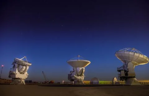 ALMA, base station of the worldwide biggest telescope Array at night, Chile Stock Photos