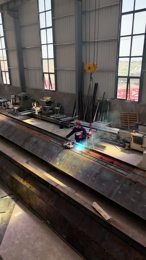 Almaty, Kazakhstan – Drone view of worker cutting steel structure at factory Stock Footage 335795029