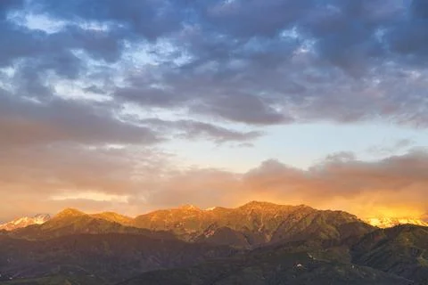 Almaty mountains illuminated by the rays of the setting sun at sunset Stock Photos