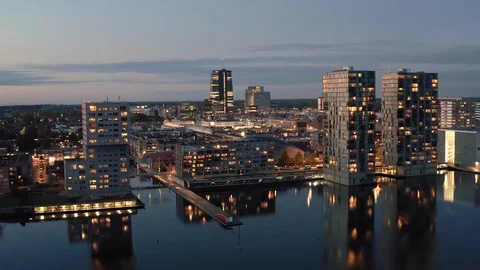 Almere city center with its modern architecture illuminated at dusk Stock Footage