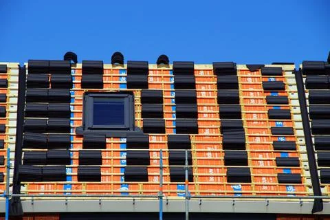 Almere, the Netherlands - May 1, 2015: Rooftop tiles on a rooftop during house c Stock Photos