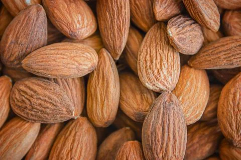 Almond background. Close-up of raw almonds, full frame. Stock Photos
