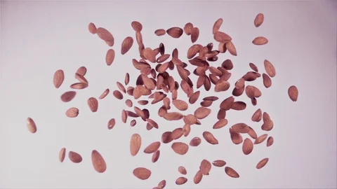 Almond falling on White Surface and Multiplies Stock Footage 115211426