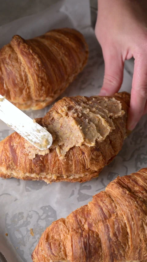 Almond frangipane cream spread on top of croissant with spatula before baking. Stock Footage 337382011