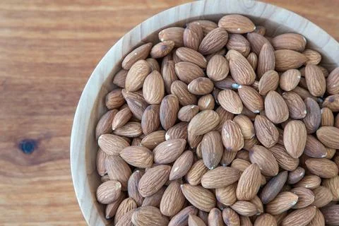 Almond kernel in a bowl. Background view from above. Healthy food. Stock Photos
