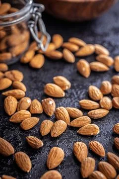 Almond kernel nuts on black table. Stock Photos