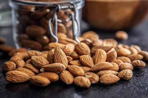 Almond kernel nuts on black table. Stock Photos
