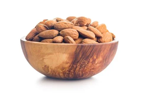 Almond kernel nuts in bowl isolated on white background. Stock Photos