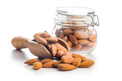 Almond kernel nuts on scoop isolated on white background. Stock Photos