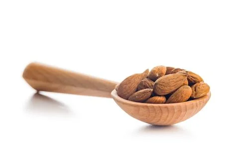 Almond kernel nuts on scoop isolated on white background. Stock Photos