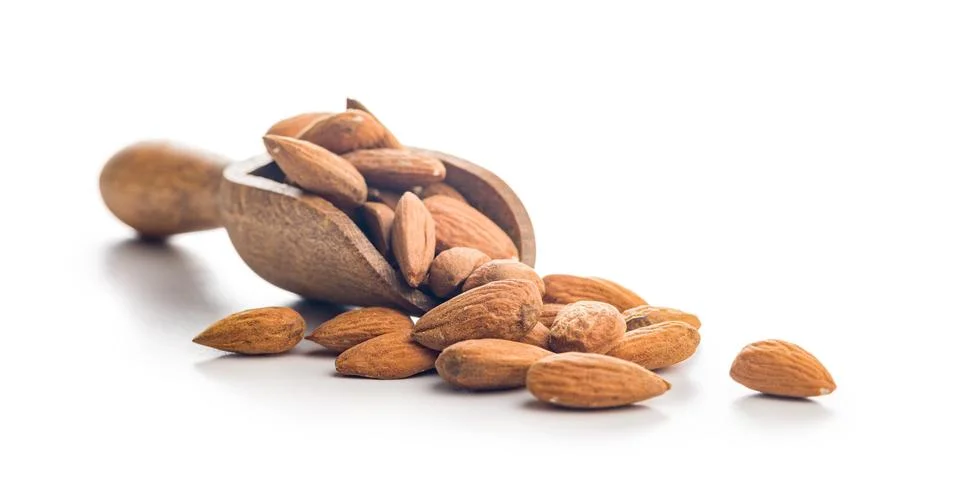 Almond kernel nuts on scoop isolated on white background. Stock Photos