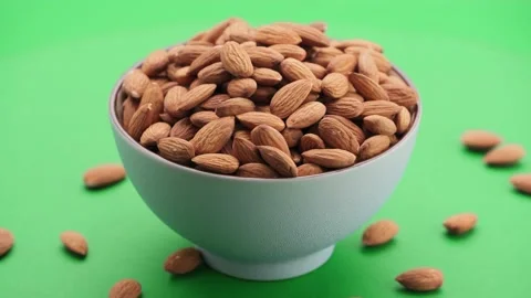 Almond kernels in a bowl, angle view, green screen background, chroma key. Video stock 154760643
