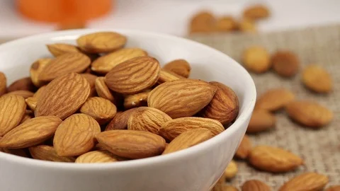 Almond nuts are in a white bowl Stock Footage 123795013