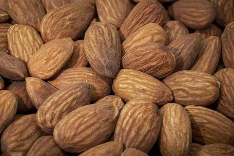 Almond nuts background. Close-up image of raw almonds Stock Photos