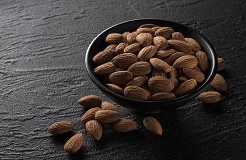 Almond nuts on black background, top view Stock Photos