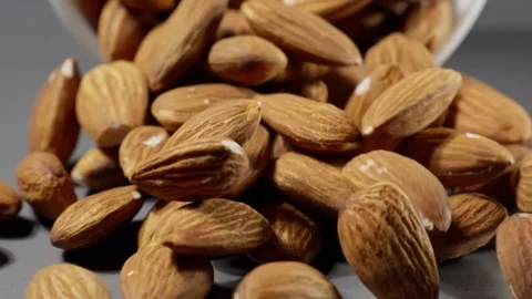 Almond nuts fall on table. Falling almonds on grey background. Healthy food Stock Footage 294188054