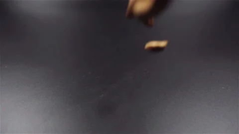 Almond nuts falling in slow motion on black background Video stock 104575900