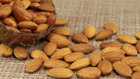 Almond nuts lie in a coconut shell Stock Footage 123821577
