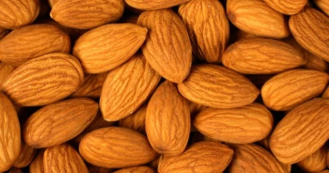 Almond nuts rotating in slow motion. Extreme close up top view, shot on RED 6K Stock Footage 107387740