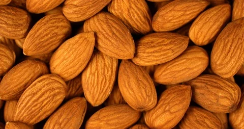 Almond nuts rotating in slow motion. Extreme close up top view, shot on RED 6K Stock Footage 107388323