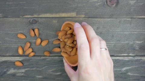 Almond nuts sprinkled on a dark table. Stock Footage 138831772