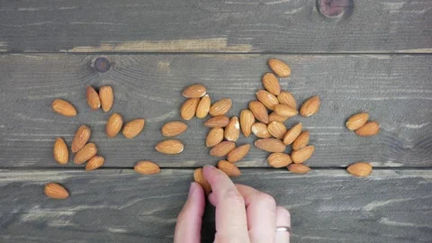 Almond nuts sprinkled on a dark table. 스톡 동영상 138831789