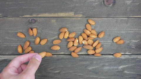 Almond nuts sprinkled on a dark table. 스톡 동영상 138831793