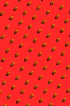 Almond pattern on red background, colorful flat lay food texture top view Stock Photos