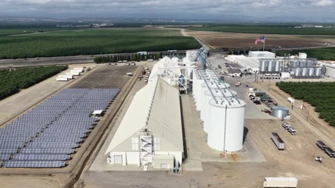 Almond processing facility with large grain silos, solar panel array and Video stock 337529151