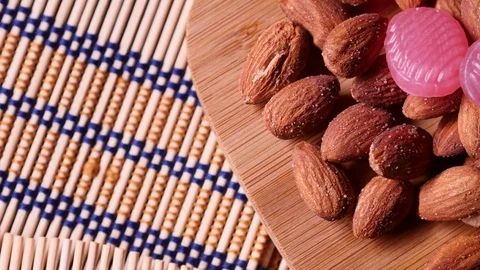 Almonds and sweets on a wooden background. 4K UHD Stock Footage 73052453