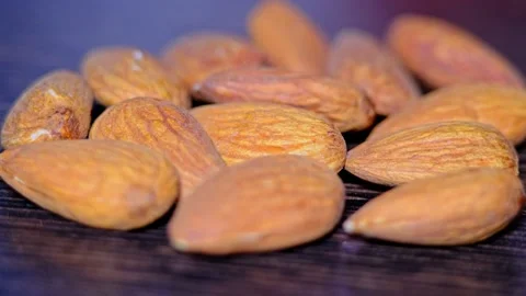 Almonds appear in light and go into dark. Healthy food. Beautiful background. Cl Stock Footage 247018093