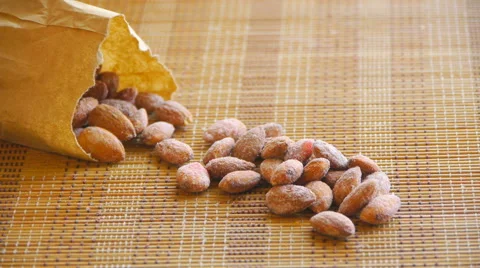 Almonds are on the table, poured out of a paper bag, camera zoom Stock Footage 67639490